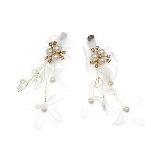 Detail of white tulle flower hair clip with pearls, rhinestones and long tassel chains