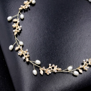 Elegant gold bridal headband with delicate pearls and crystals in floral vine design