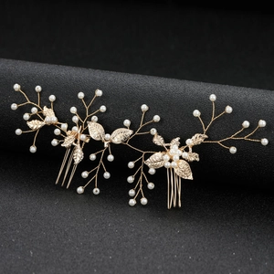 Macro detail of gold bridal hair combs with pearls and leaves for wedding hairstyles