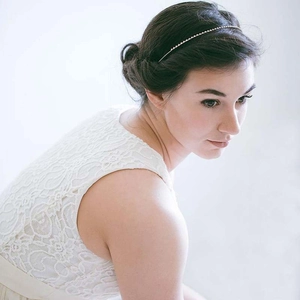 Sparkling bridal headband with full crystals on elegant updo hairstyle for weddings