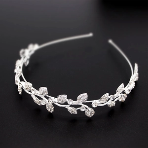 Macro detail of silver bridal tiara with sparkling rhinestones and leaf-shaped patterns