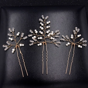 Three-piece set of bridal hair pins with golden wires, white pearls and clear crystals