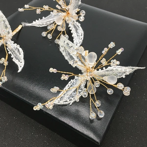 Elegant bridal hair clips set with white lace floral beads and golden wire details