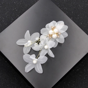 Exquisite white floral bridal hair clip with organza petals and pearls on black box