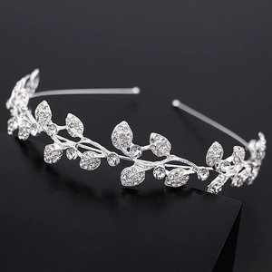 Close-up of sparkling silver bridal crown with leaf patterns and rhinestones on black