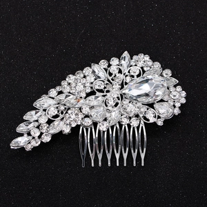 Elegant bridal hair comb with silver rhinestones and pear-shaped crystals on black surface