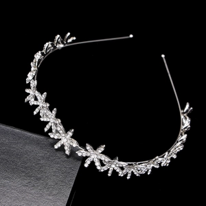 Detailed view of silver star petals with shimmering rhinestones on a bridal headband