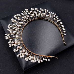 Détail d'un serre-tête tressé à la main en fil doré avec perles blanches pour mariée