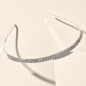 Macro shot of silver bridal headband with double-row sparkling rhinestones on pedestal