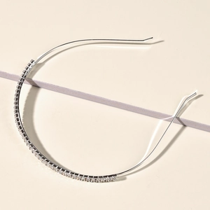 Detailed macro view of thin silver bridal headband with sparkling rhinestone inlay