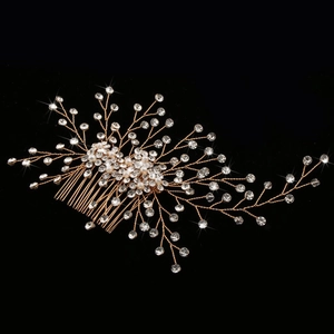 Sparkling gold bridal hair comb with handmade crystals and pearls on a black background