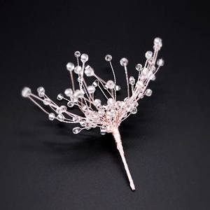 Detail view of handcrafted rose gold wire and transparent beads in a snowflake starburst design