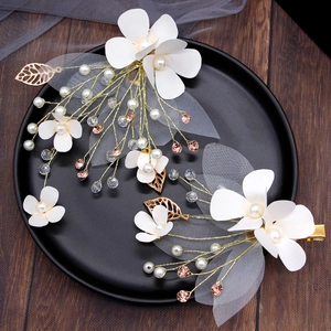 Elegant ivory floral hair clips with pearls and crystals for wedding hairstyles