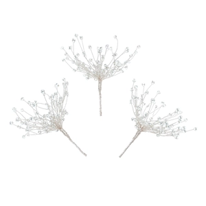 Macro detail of three handmade silver bridal hair pins with delicate beaded snowflakes