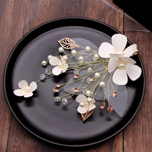 Handmade ivory floral hair clips set with pearls and gold leaves for bridal wedding hair