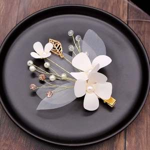 Set of ivory flower hair clips with pearls and gold leaves for elegant bridal hairstyles