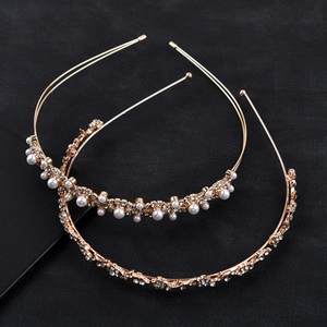 Détail d'un ensemble de serre-têtes en alliage doré avec perles et strass brillants