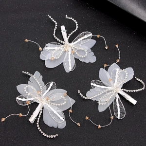 Set of three white lace butterfly hair pins with elegant crystal tassels for brides