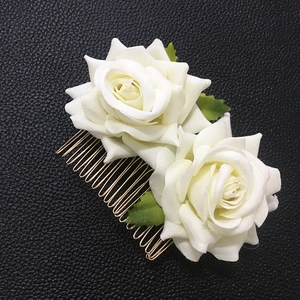 Detail of white fabric double rose hair comb with golden metal teeth for bridal styling
