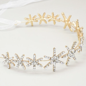 Detail view of the sparkling rhinestone star-shaped bridal headband with white ribbons