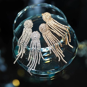 Elegant silver and gold bridal tassel earrings with brilliant rhinestones for weddings