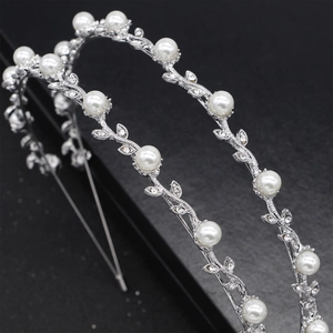 Detail of silver bridal headband with pearls and rhinestones in vine design