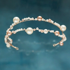 Detail of handcrafted gold wire bridal headband with elegant pearls and sparkling rhinestones