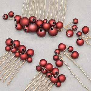 Detail of handmade red pearls and gold wire wrapping on bridal hair comb set