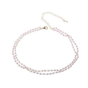 Close-up of double-layer pearl necklace with golden lobster clasp and adjustable chain