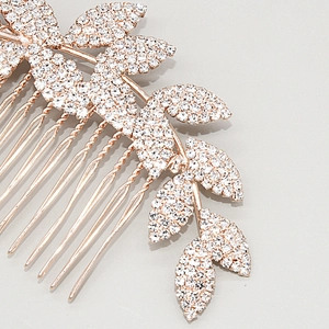 Close-up detail of rose gold bridal hair comb with wave leaf patterns and white rhinestones
