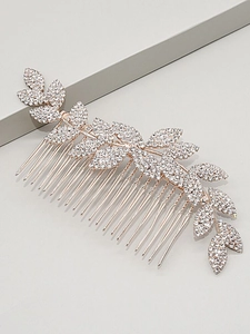 Close-up of rose gold bridal hair comb with rhinestone-encrusted leaves for weddings