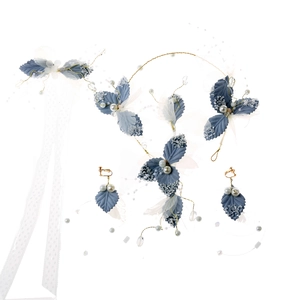 Detailed shot of handmade blue leaf bridal headband set with matching pearl earrings