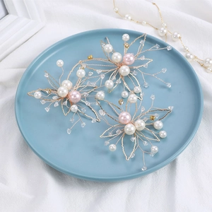 Bridal leaf hairpins set of 3 with pearls and crystals on a light blue ceramic tray