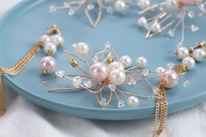 Handmade bridal hair accessories set with pearls and crystals in a ceramic dish