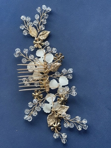 Detail view of handmade bridal hair comb with golden leaves, pearls and crystal beads