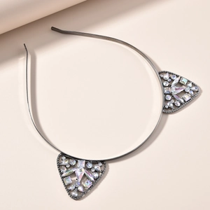Détail d'un serre-tête oreilles de chat orné de strass multi-formes et monture métallique