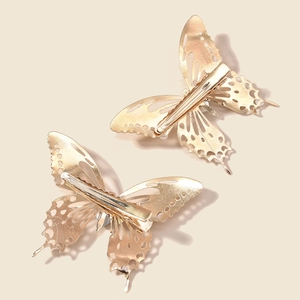 Set of two gold butterfly hair clips with opal accents and intricate hollow alloy design