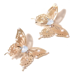 Golden butterfly hair clips with opals and pearls in a pair for elegant hair styling