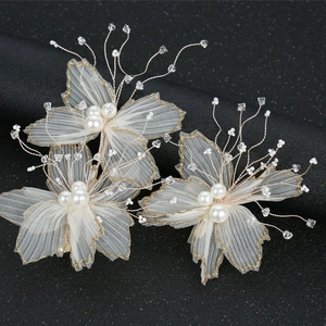 Bridal hair set with white gauze flowers, pearls, and gold glitter accents for weddings