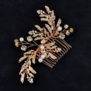 Elegant gold bridal hair comb with alloy leaves, pearls and crystals on black background