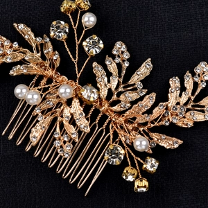 Detailed macro shot of golden leaf hair comb with white pearls and sparkling rhinestones