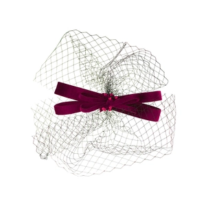Close-up of deep burgundy velvet bow hair clip with bead details and black mesh veil