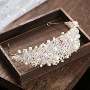 Elegant bridal crown with handmade pearls and sparkling crystals on vintage wood box