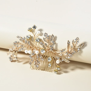 Close-up of golden leaf bridal hair comb with pearls and sparkling crystals detail