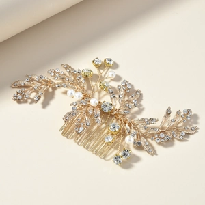 Detail shot of vintage bridal hair comb with gold alloy leaves, rhinestones and pearls