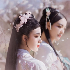 Detail view of pink gauze flower hairpins with long tassels for bridal hairstyling