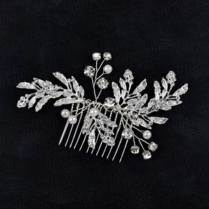 Silver bridal hair comb with alloy leaves, rhinestones, and pearls on black background