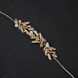 Elegant bridal hairband featuring gold alloy leaves with inlaid pearls and sparkling rhinestones