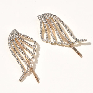 Macro detail of bridal angel wing hair clips with sparkling white rhinestones