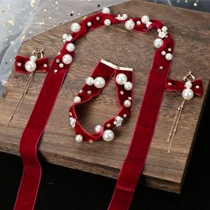 Bridal burgundy velvet hair set with pearls and rhinestones on a wooden display